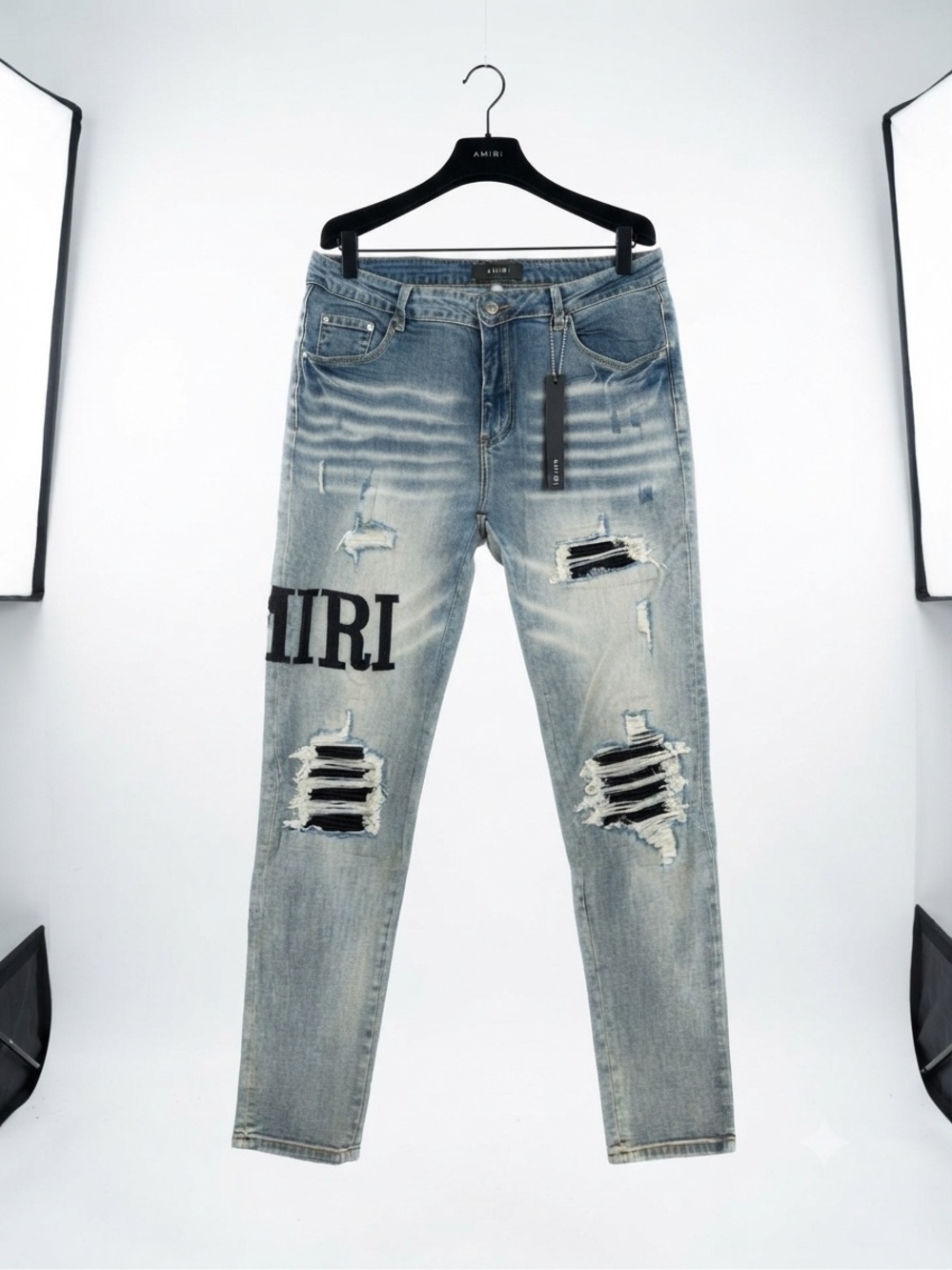 AMIRI Light Blue Distressed Jeans with Black Logo